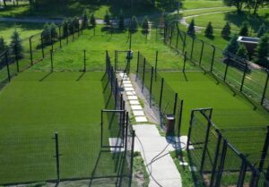 Fenced outdoor grass yards where boarding dogs go out to play